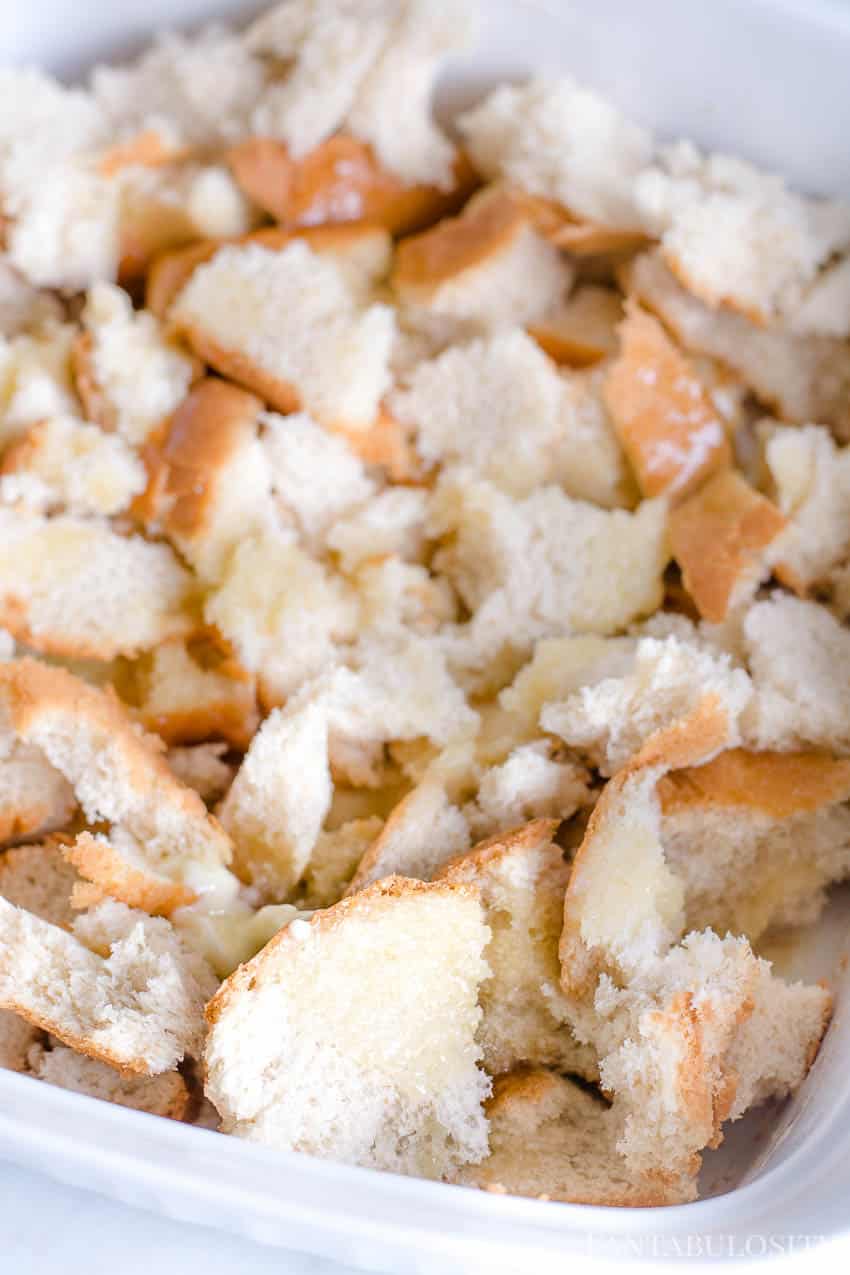 Uncooked bread cubes in baking dish