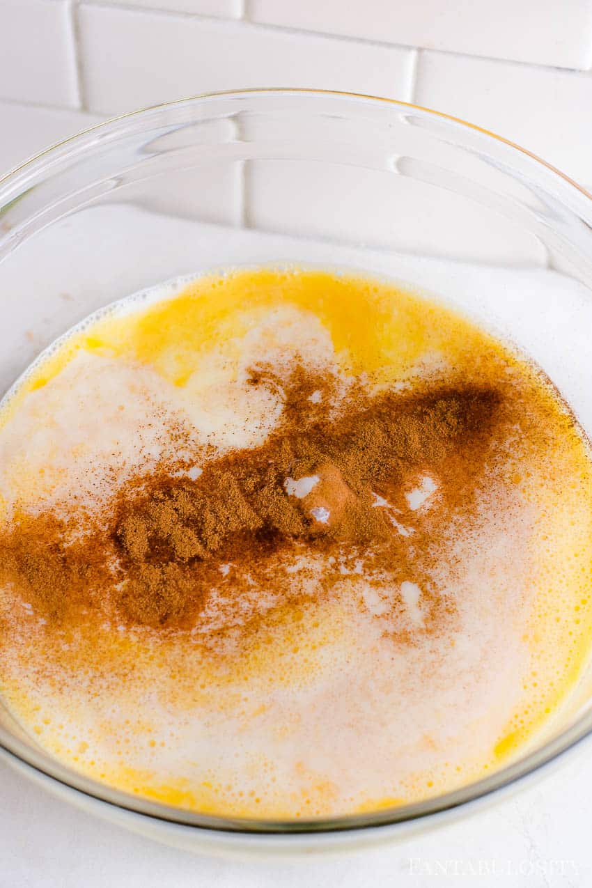 eggs, milk, cinnamon, sugar, butter in large mixing bowl ready to be mixed