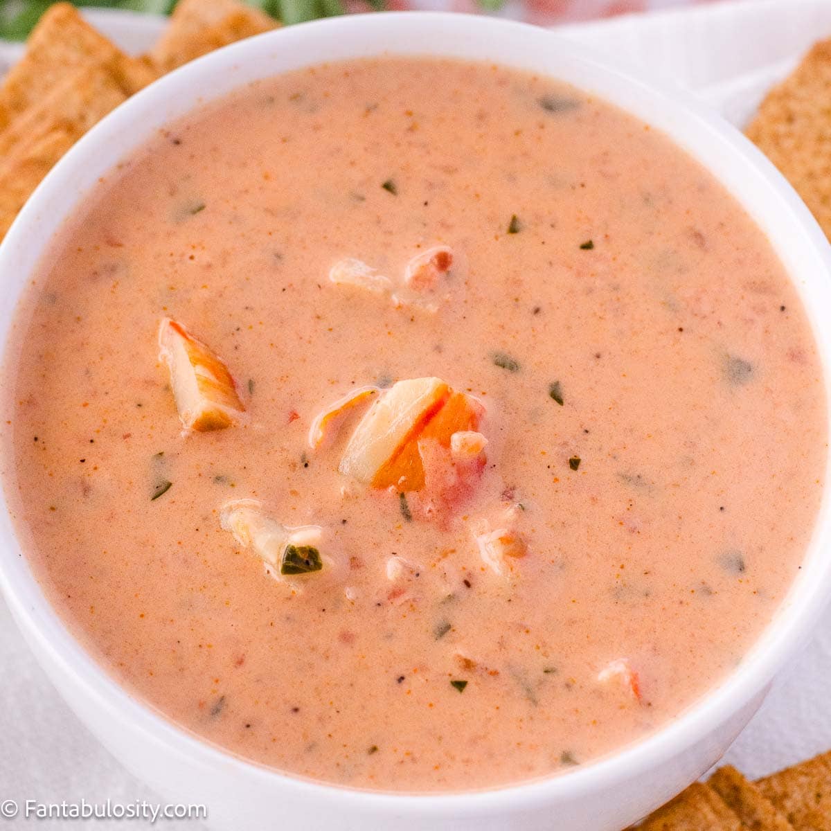 Bowl of lobster bisque with crackers.