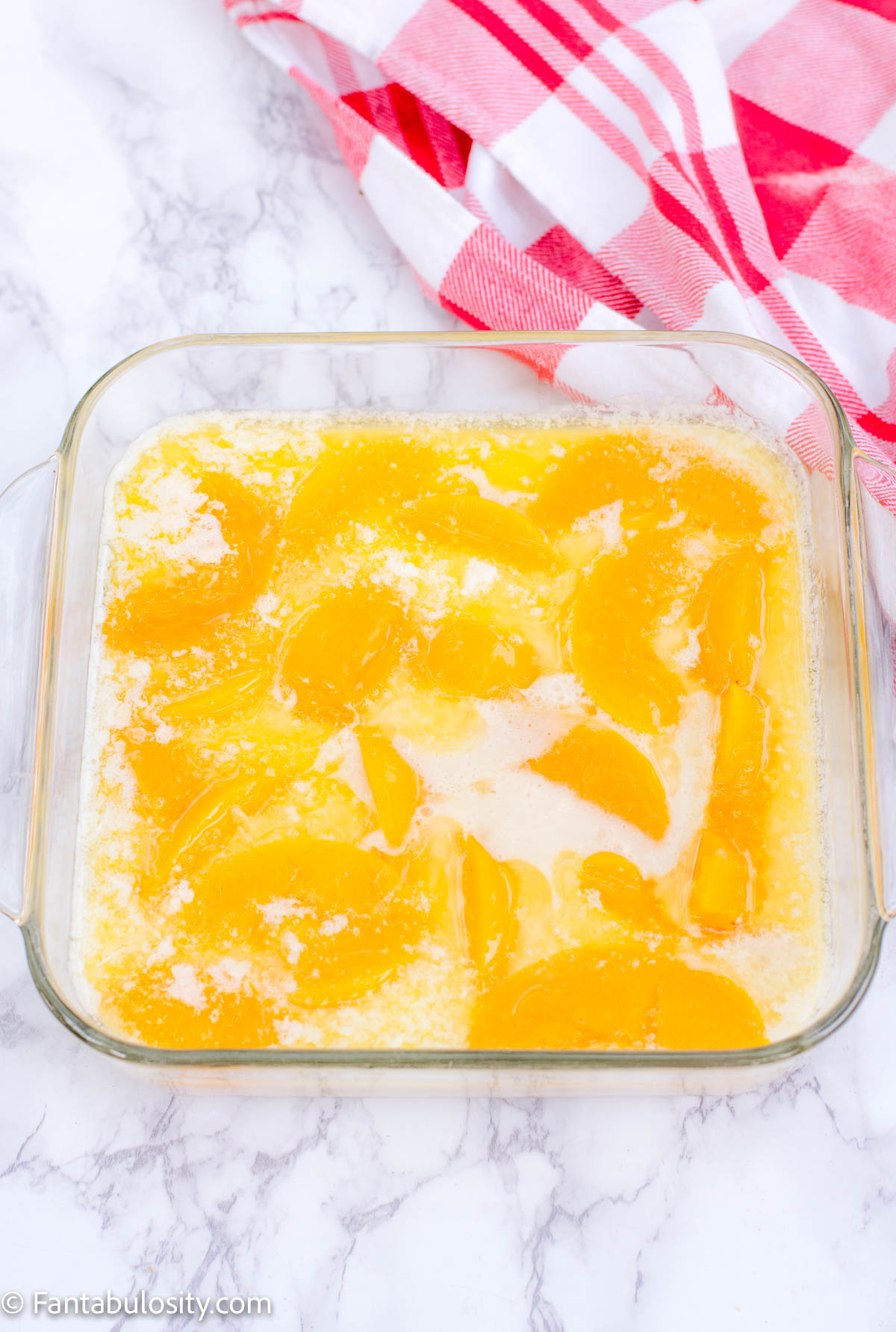 Place canned peaches (without juice) on top