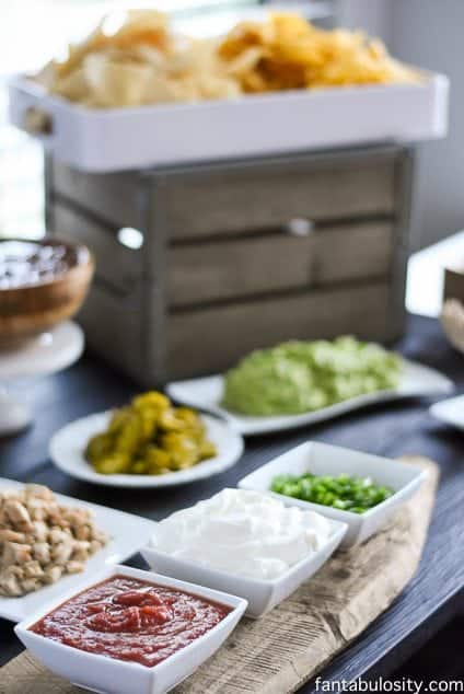 White dishes full of salsa, sour cream, green onions