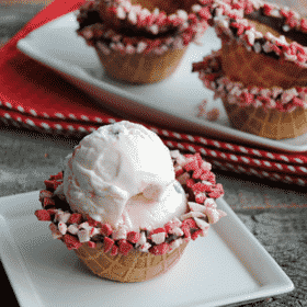 Regular waffle cone bowls are way more fun when they are dipped in chocolate and peppermint chips! Chocolate Dipped Waffle Cone Bowls are such a fun way to serve ice cream, pudding or any sweet treat!