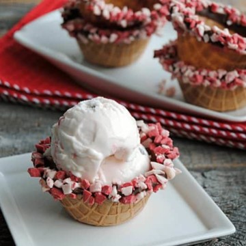 Regular waffle cone bowls are way more fun when they are dipped in chocolate and peppermint chips! Chocolate Dipped Waffle Cone Bowls are such a fun way to serve ice cream, pudding or any sweet treat!