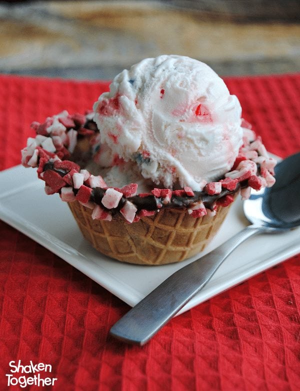 Regular waffle cone bowls are way more fun when they are dipped in chocolate and peppermint chips! Chocolate Dipped Waffle Cone Bowls are such a fun way to serve ice cream, pudding or any sweet treat!