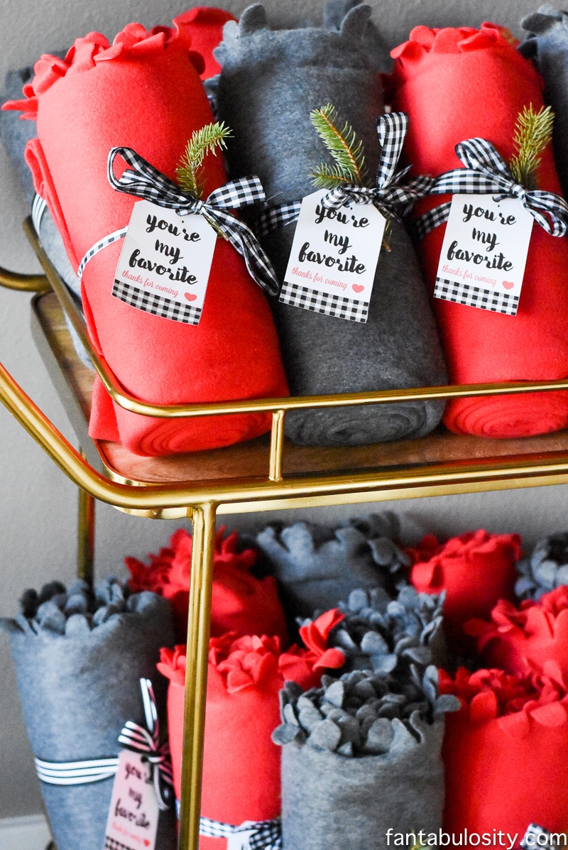 Fleece Blankets with ribbon and spruce sprigs and tags. Favorite Things Party Ideas - How to Host Favorite Things Party Favors