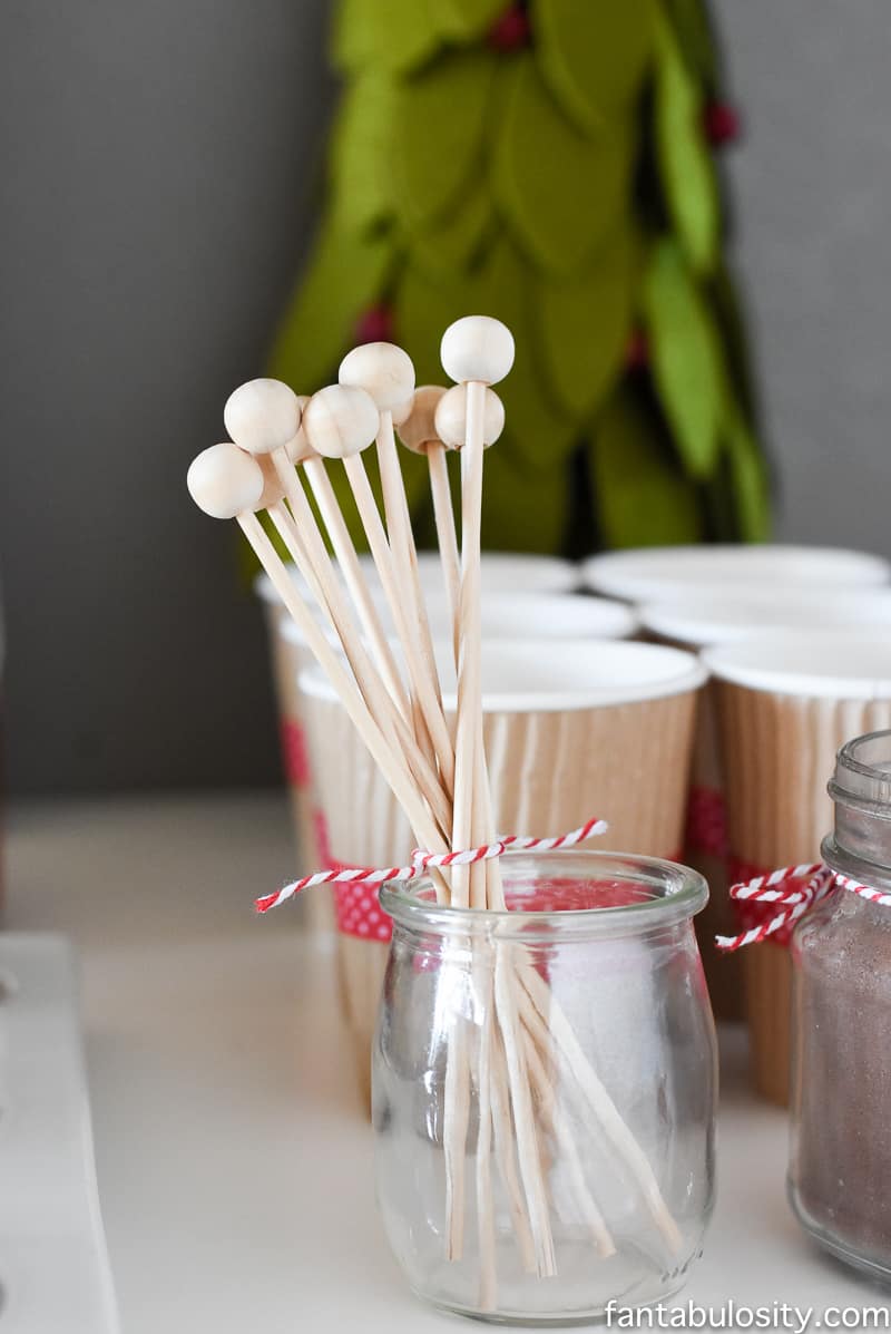 Such a cute idea! Love these drink stirrers. Hot chocolate station on a dessert table! Vintage Christmas Party Ideas: Truck with Christmas Tree, cupcakes, red green and white, hot chocolate bar