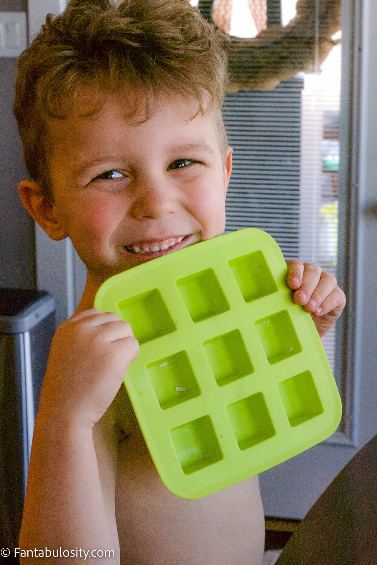 Toddler holding ice cube tray