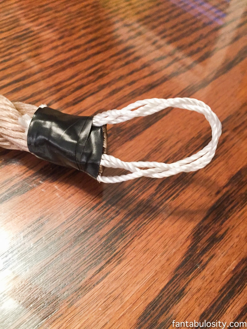 Use electrical tape to tape the twisted mason line, to create a hook for the curtain tie back