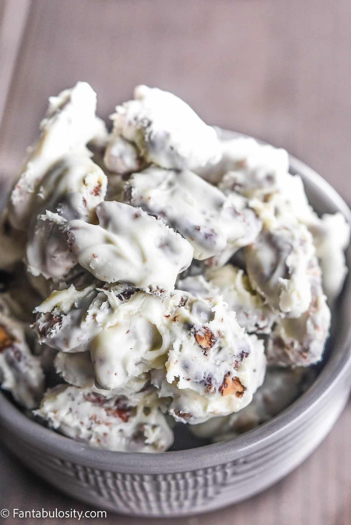 white chocolate pecans in gray bowl