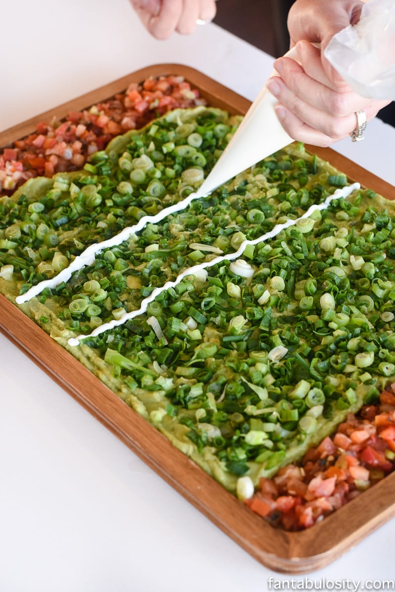 Football Party Food: Field made of guacamole and pico de gallo, then a football shaped dip! So fun!