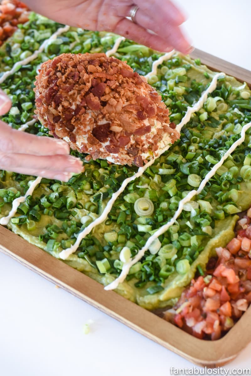 Football Party Food: Field made of guacamole and pico de gallo, then a football shaped dip! So fun!