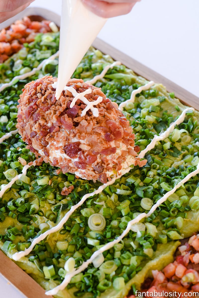 Football Party Food: Field made of guacamole and pico de gallo, then a football shaped dip! So fun!