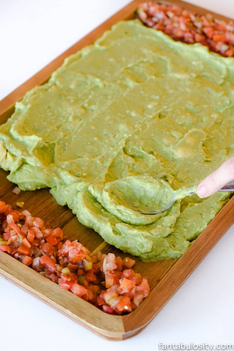 Football Party Food: Field made of guacamole and pico de gallo, then a football shaped dip! So fun!