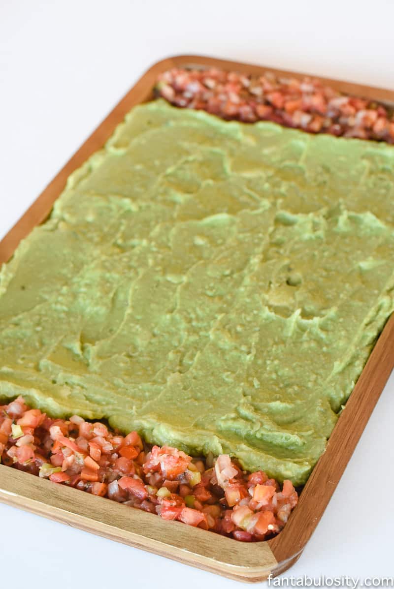 Football Party Food: Field made of guacamole and pico de gallo, then a football shaped dip! So fun!