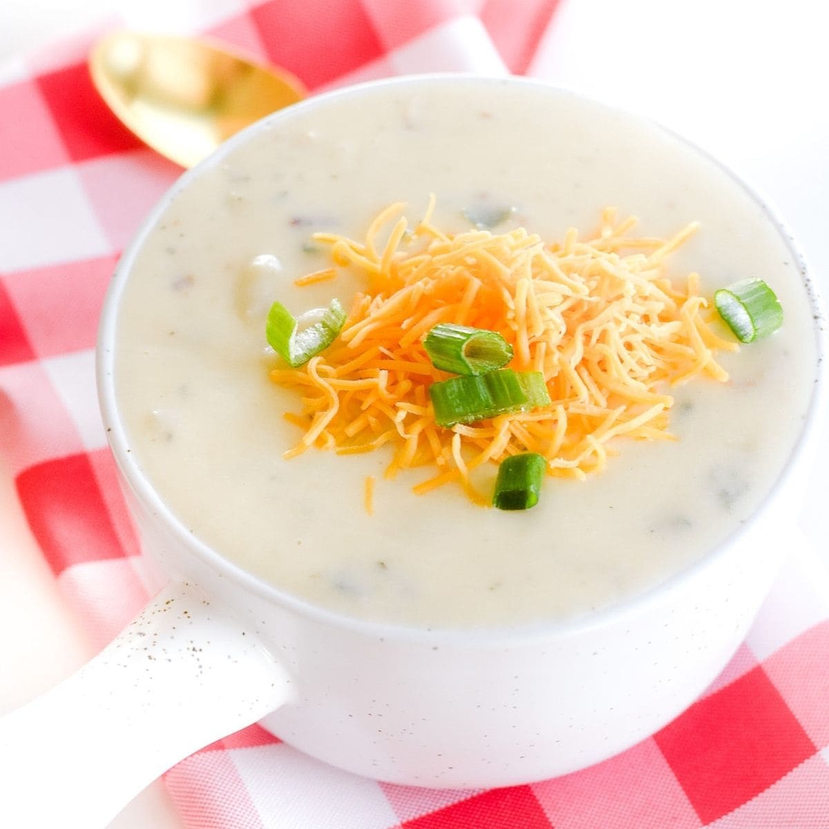 Bowl of loaded baked potato soup with bacon and cheese.