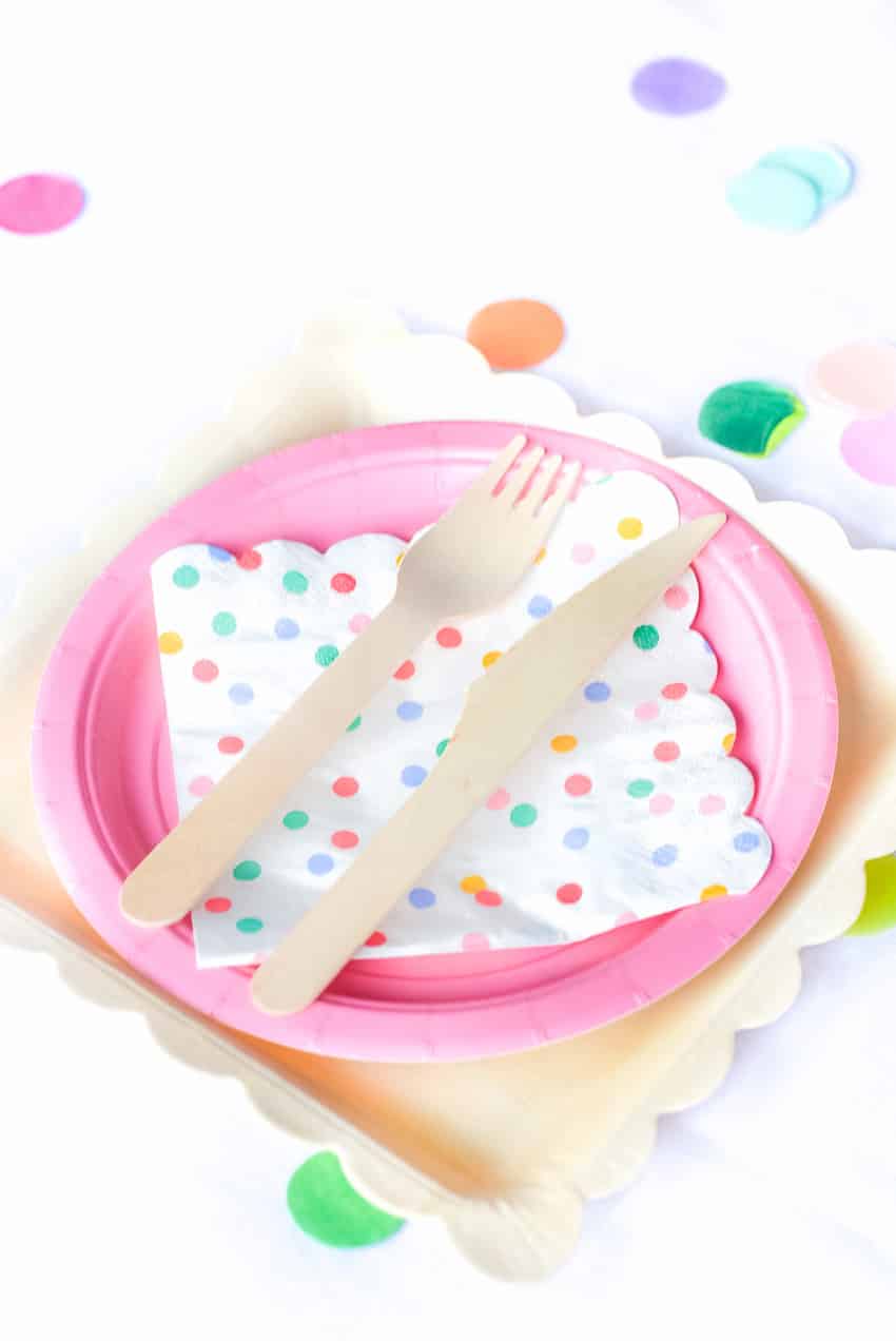 What an adorable place setting with wooden utensils for Fiesta Theme Party: A confetti and pastel fiesta party!