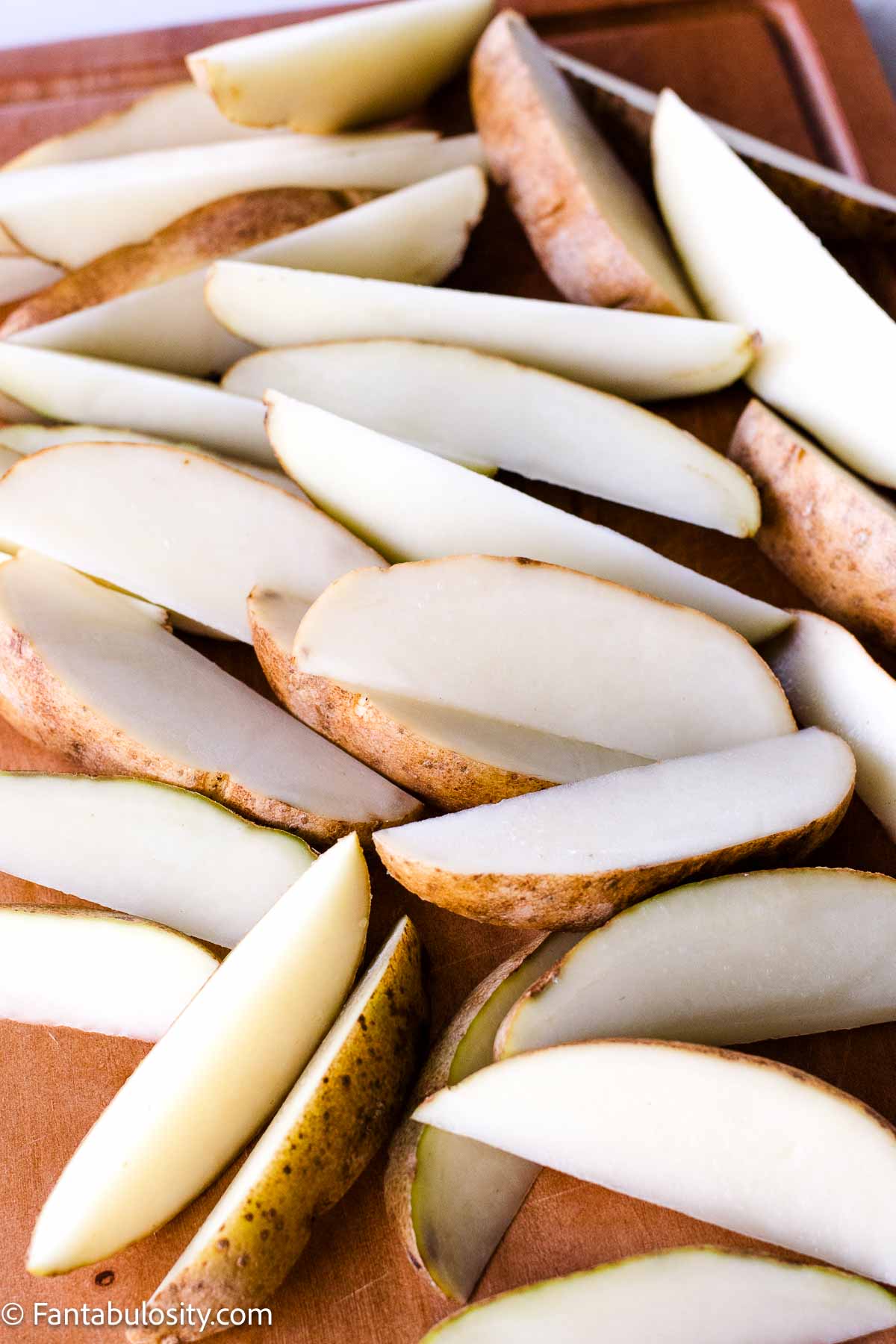 Large baking potatoes sliced in to wedges.
