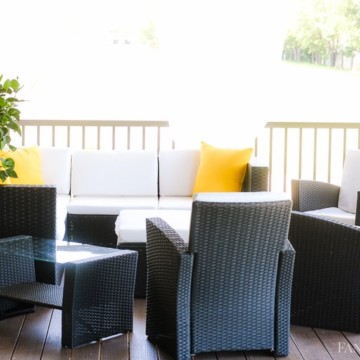 Back patio with white cushions, yellow pillows! Craftsman style home