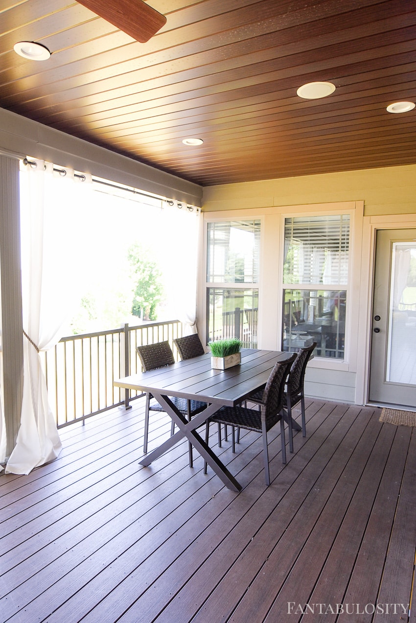 Craftsman Home Patio. Outdoor dining table for patio. Aluminum - brown with white curtains