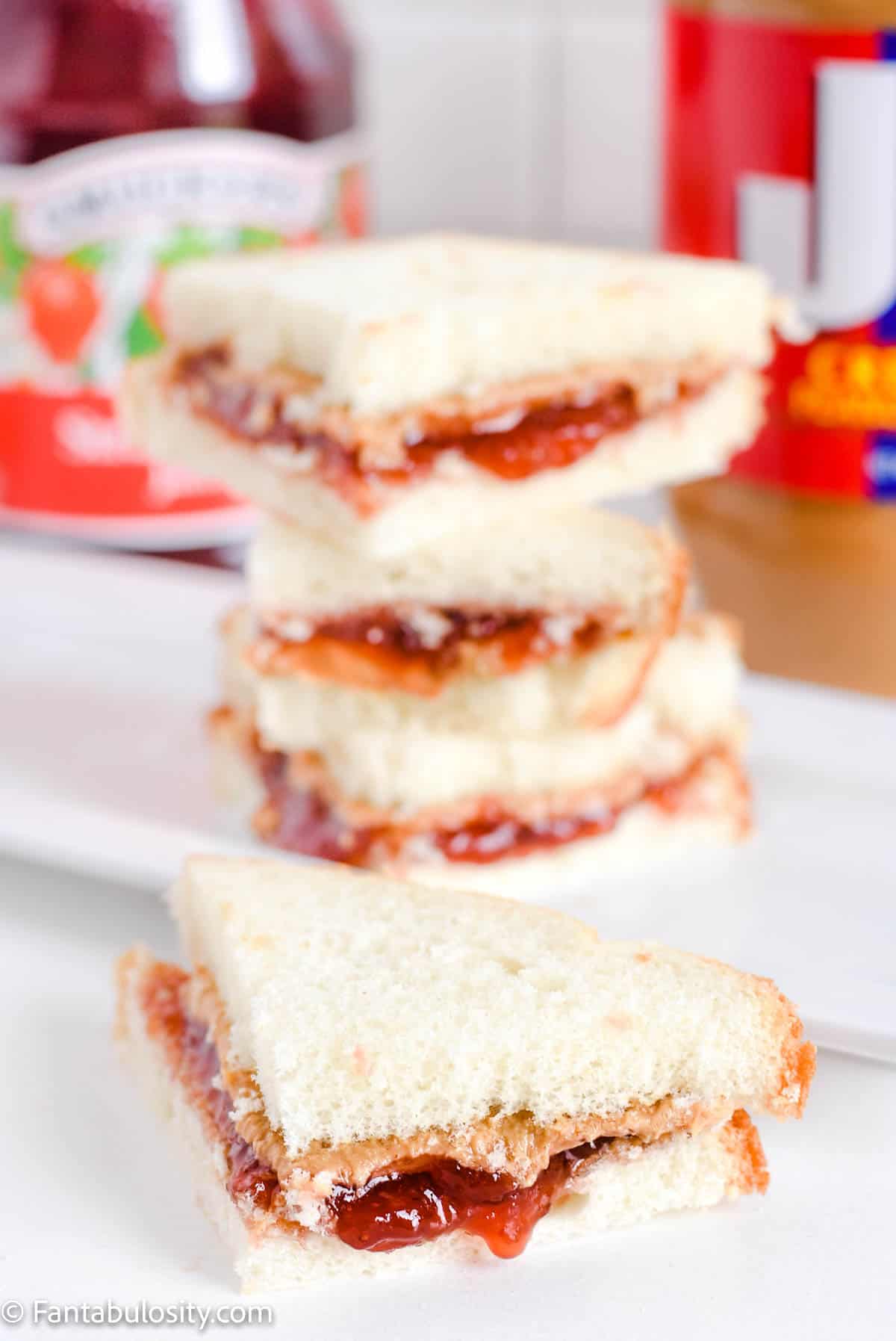 Stacked small triangles of peanut butter and jelly sandwiches