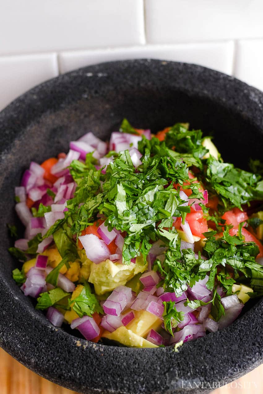 Adding ingredients in to guacamole - so easy and so pretty!