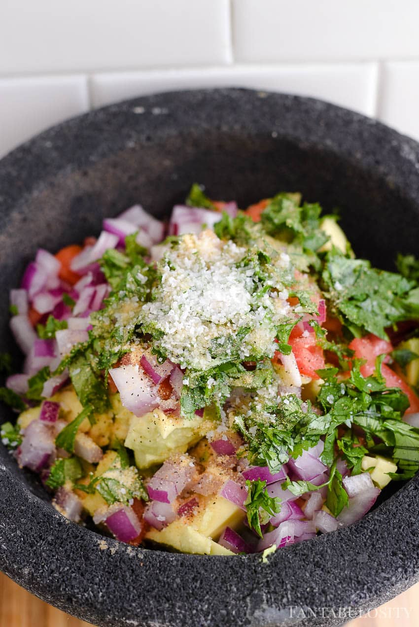 Adding spices in to guacamole recipe