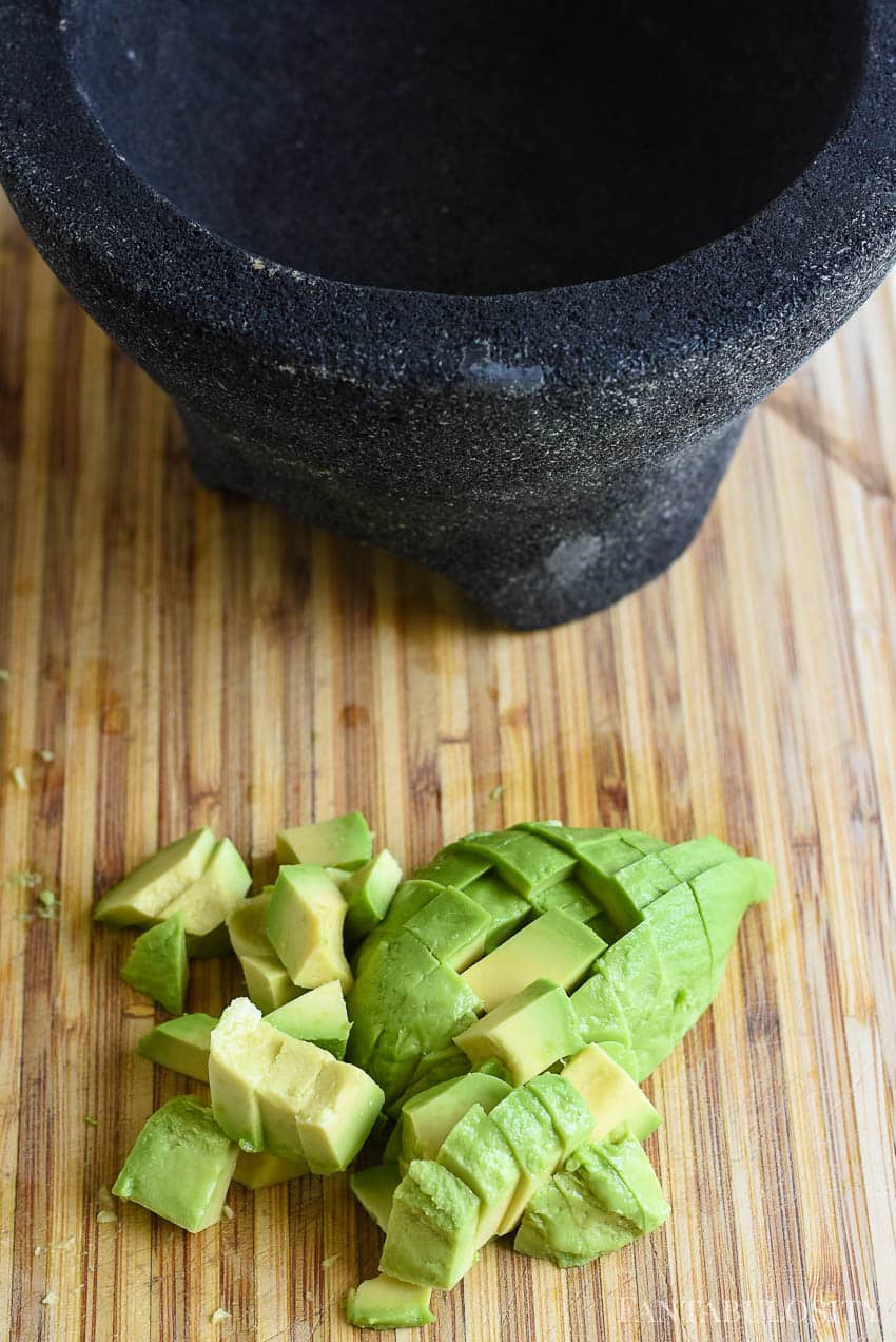 How to make guacamole recipe - easy and the best. Slice avocados and mash