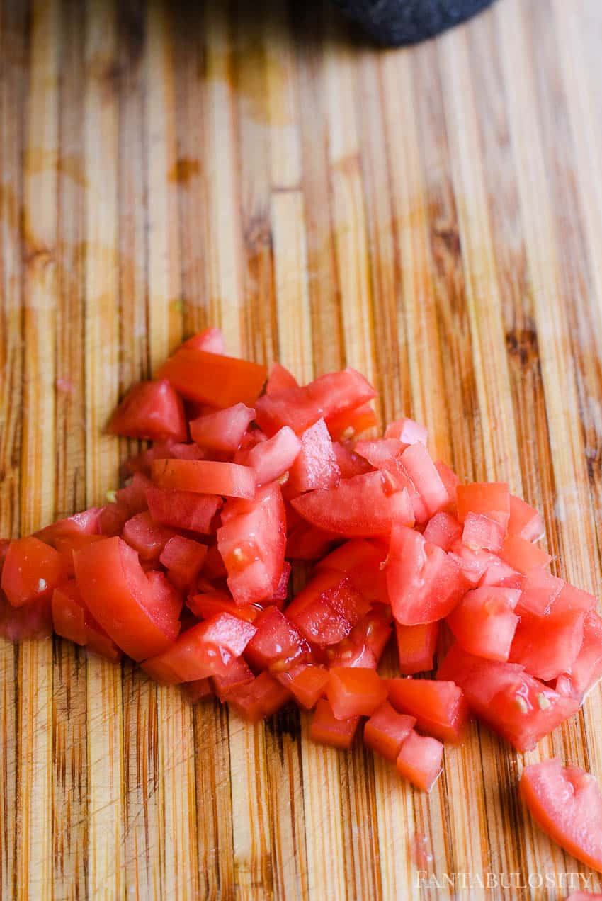 Cut roma tomatoes in to small cubes for guacamole