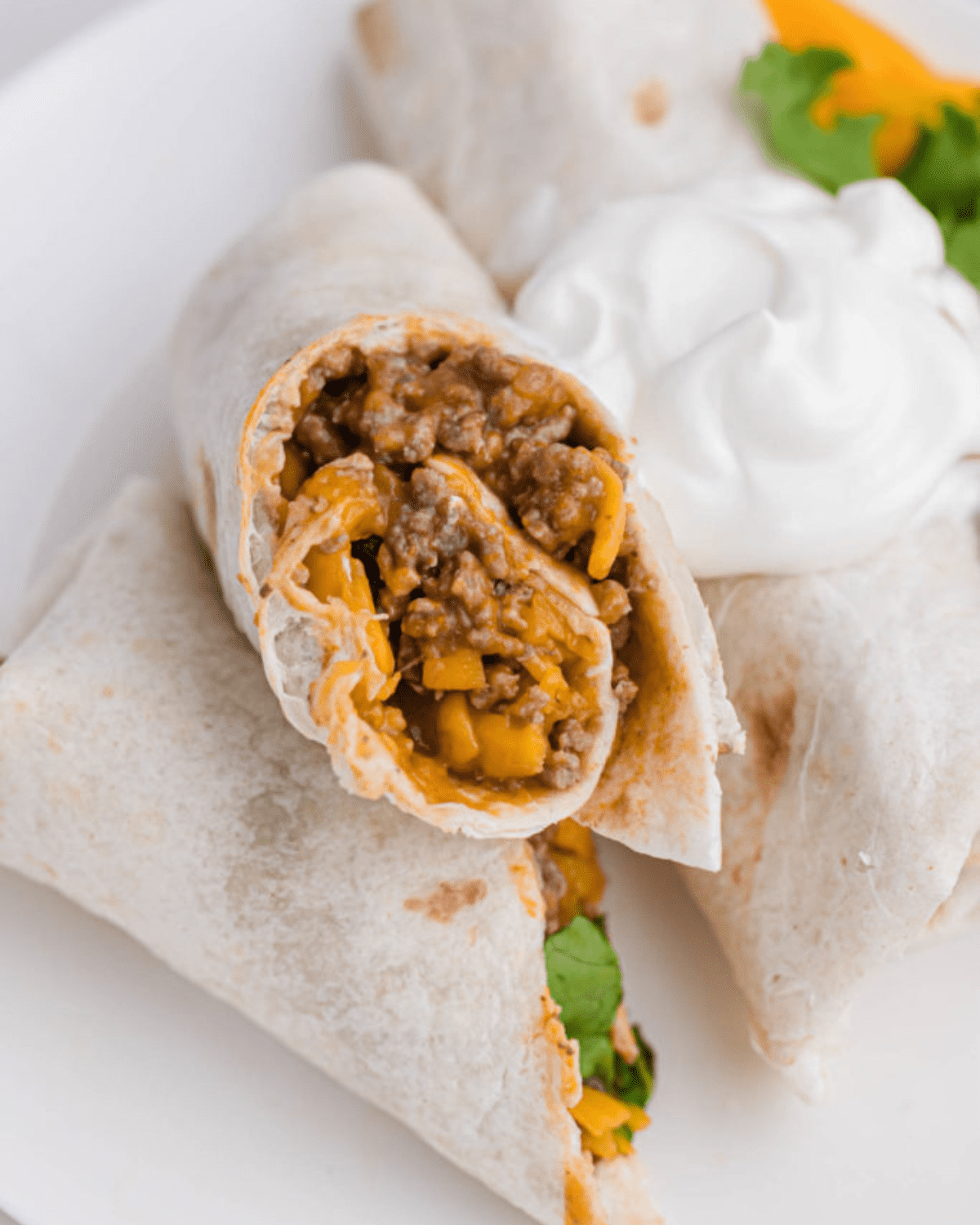 Salsa, cheese and beef burritos