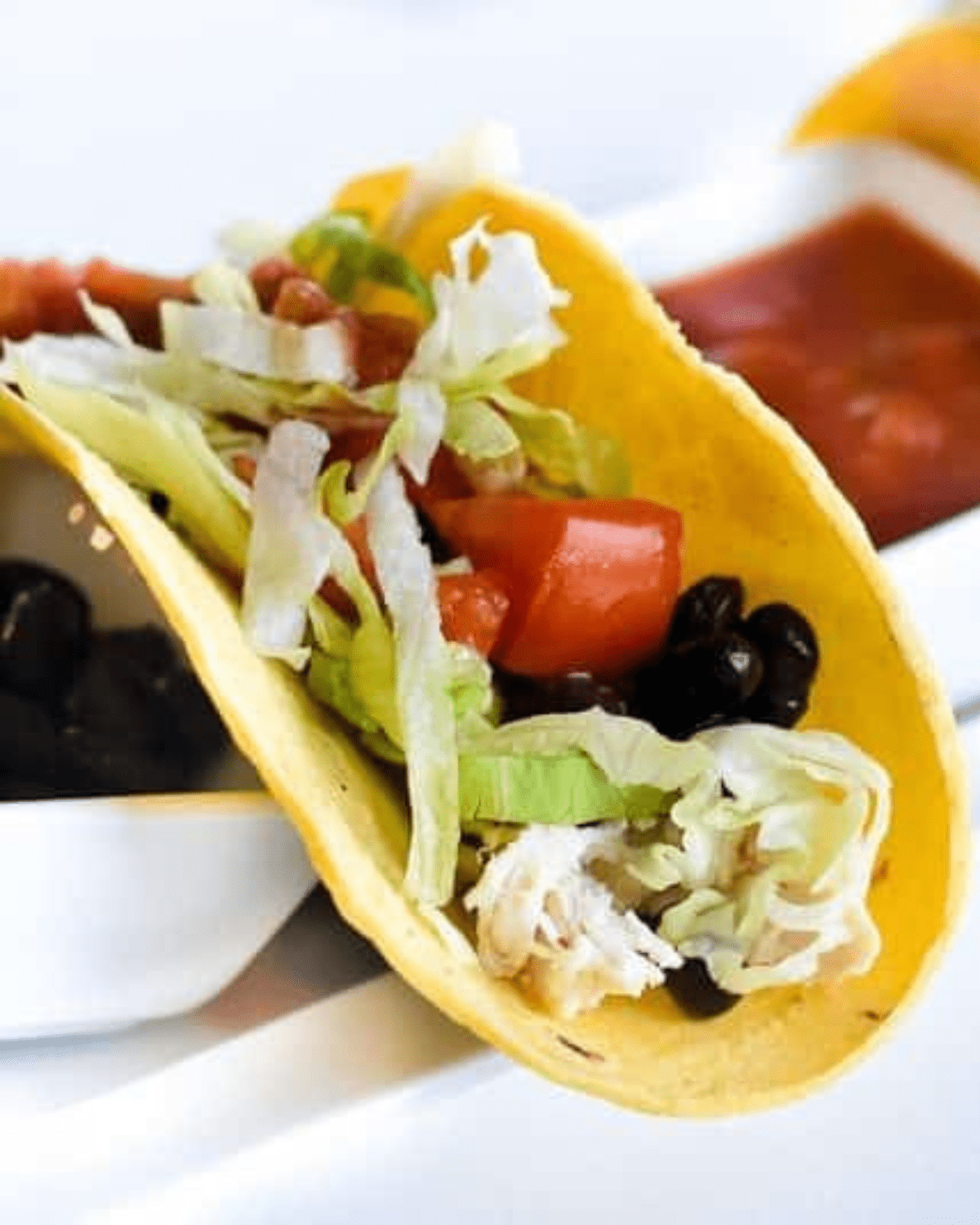 Chicken tacos with tomatoes in a taco shell