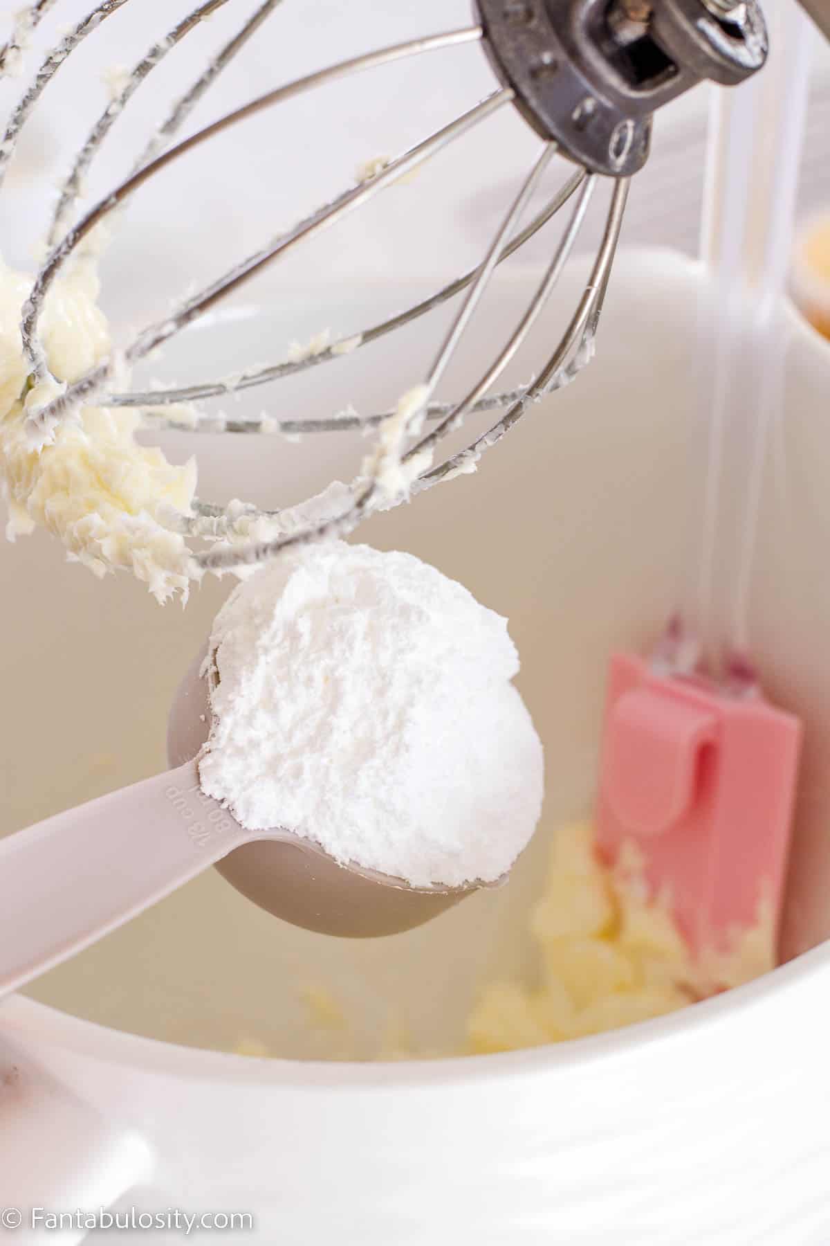 Powdered sugar pouring in to mixing bowl