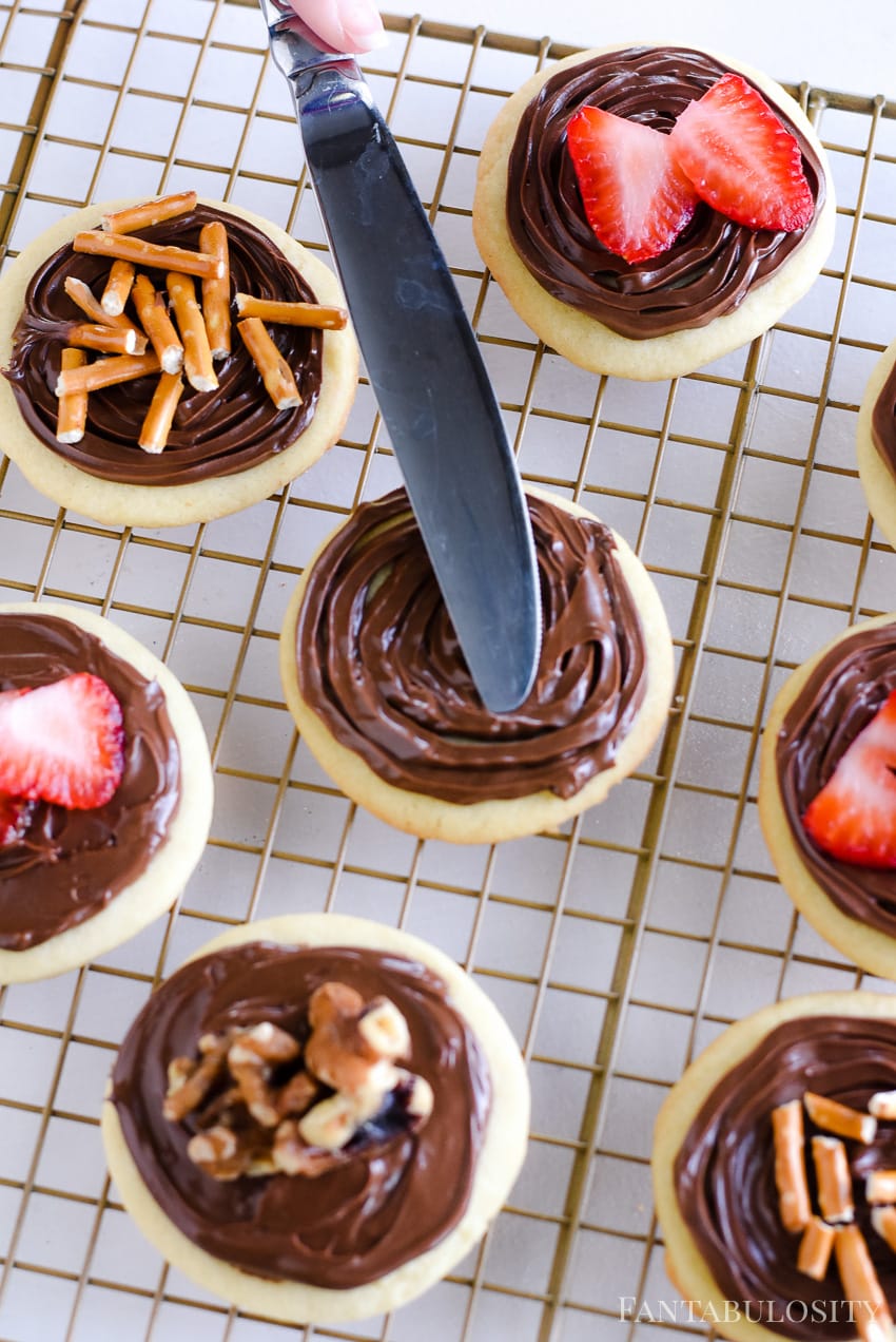 Spread Nutella on top of sugar cookies - chocolate hazelnut spread