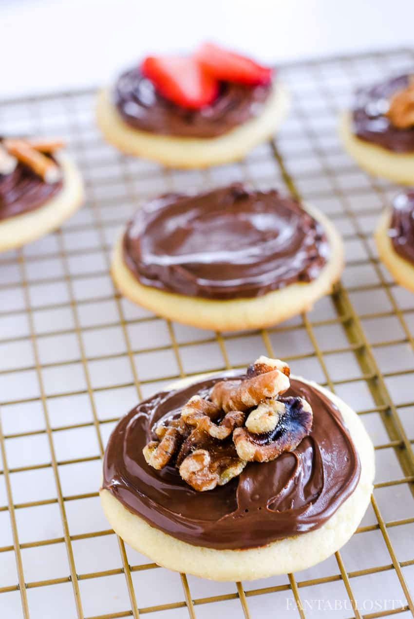 Walnuts on top of sugar cookies with Nutella