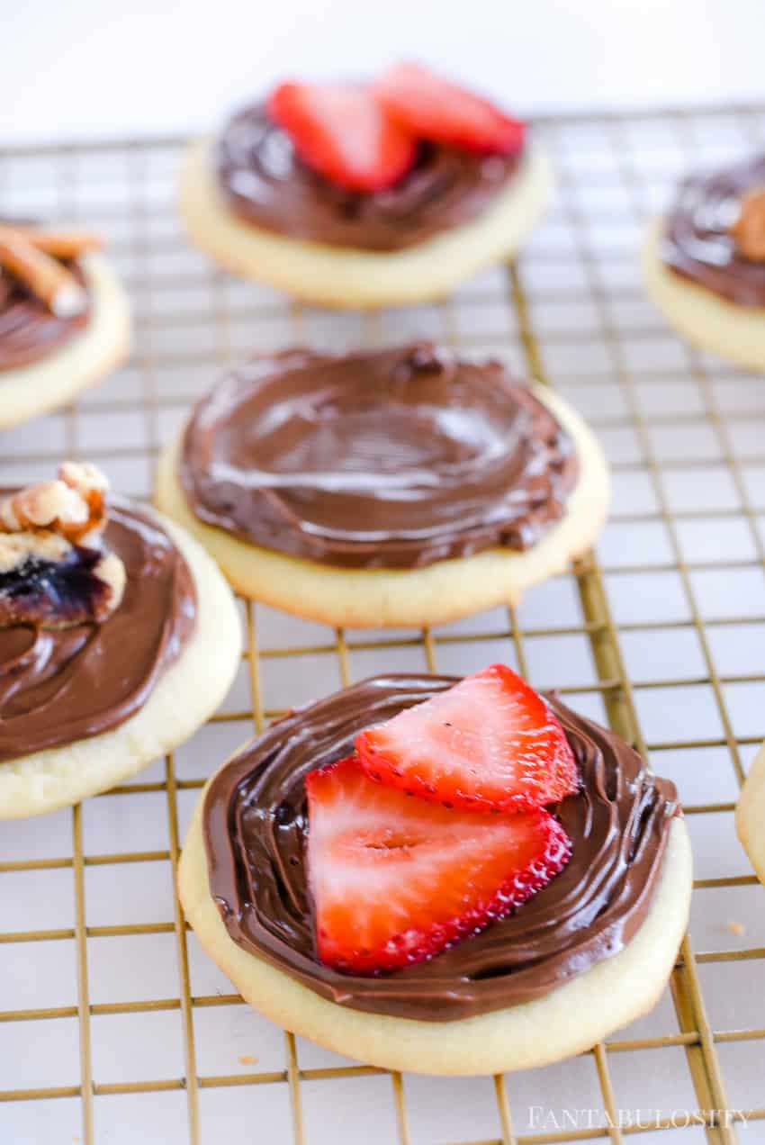 Sliced strawberries on top of sugar cookies with Nutella