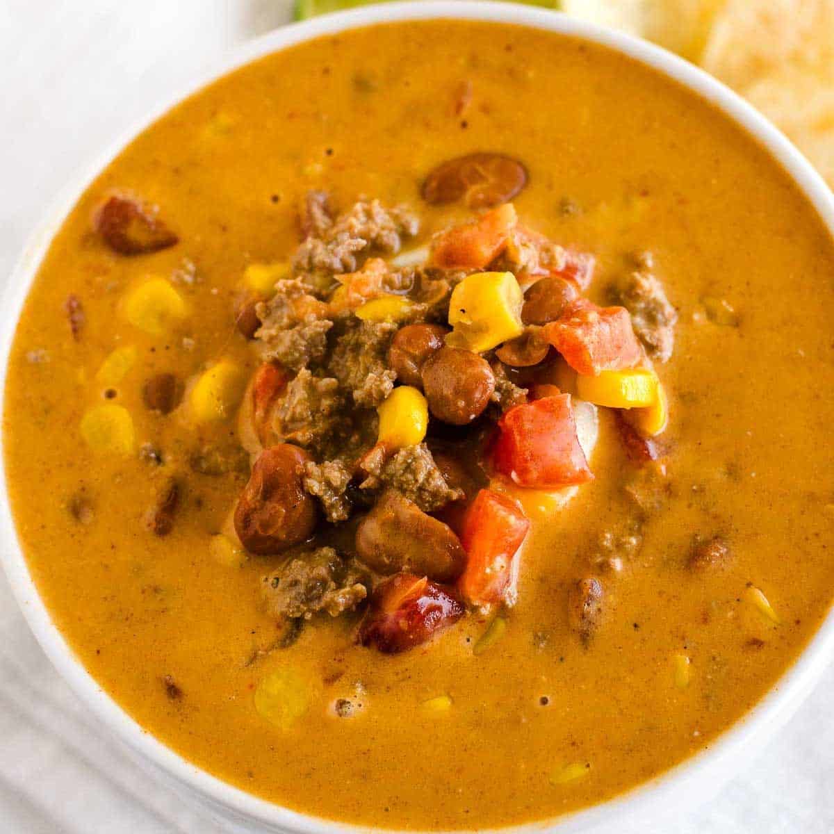 Creamy taco soup serving in white bowl.