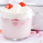 Hot strawberry drink in clear mug.