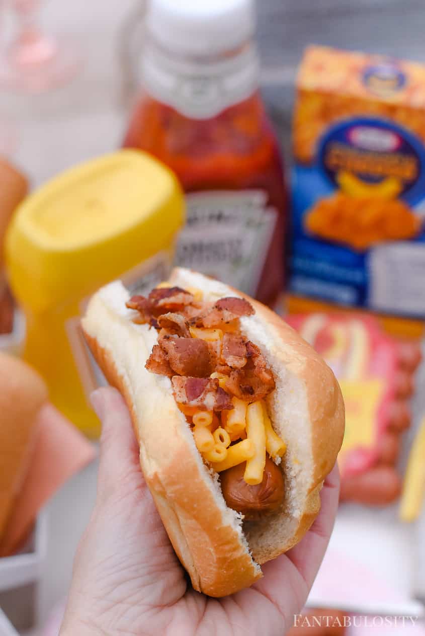 Hot dog with mac and cheese with crumbled bacon