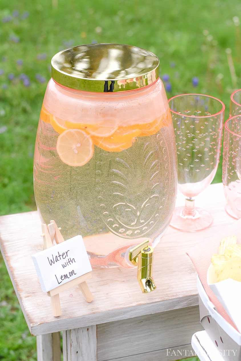 Water with Lemon for outdoor party in drink dispenser