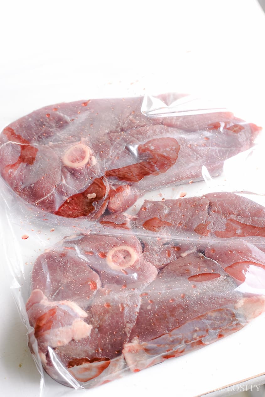 Raw deer steaks in plastic bag.