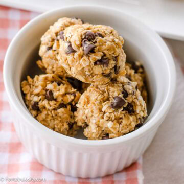 No bake energy balls in small ramekin, sitting on fabric napkin.