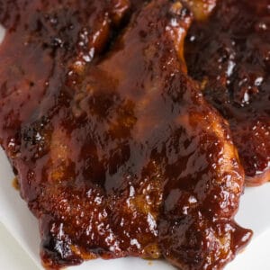 Baked BBQ Pork Steaks on white plate