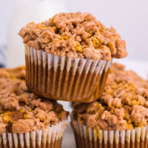 Close up of pumpkin streusel muffins stacked on top of one another