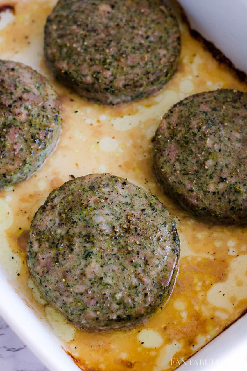 Cooked turkey burgers in white baking dish