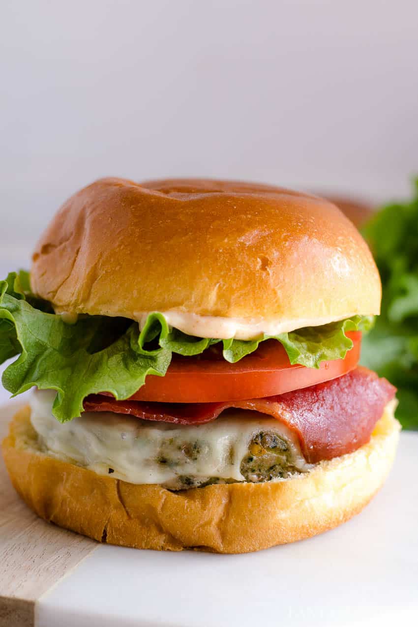 Baked Turkey Burgers on bun with lettuce and tomato and turkey bacon