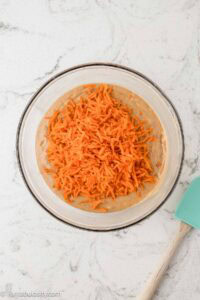 Wet and dry ingredients combined with shredded carrots added.