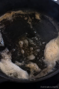 Melted browned butter in cast iron skillet for chicken bites