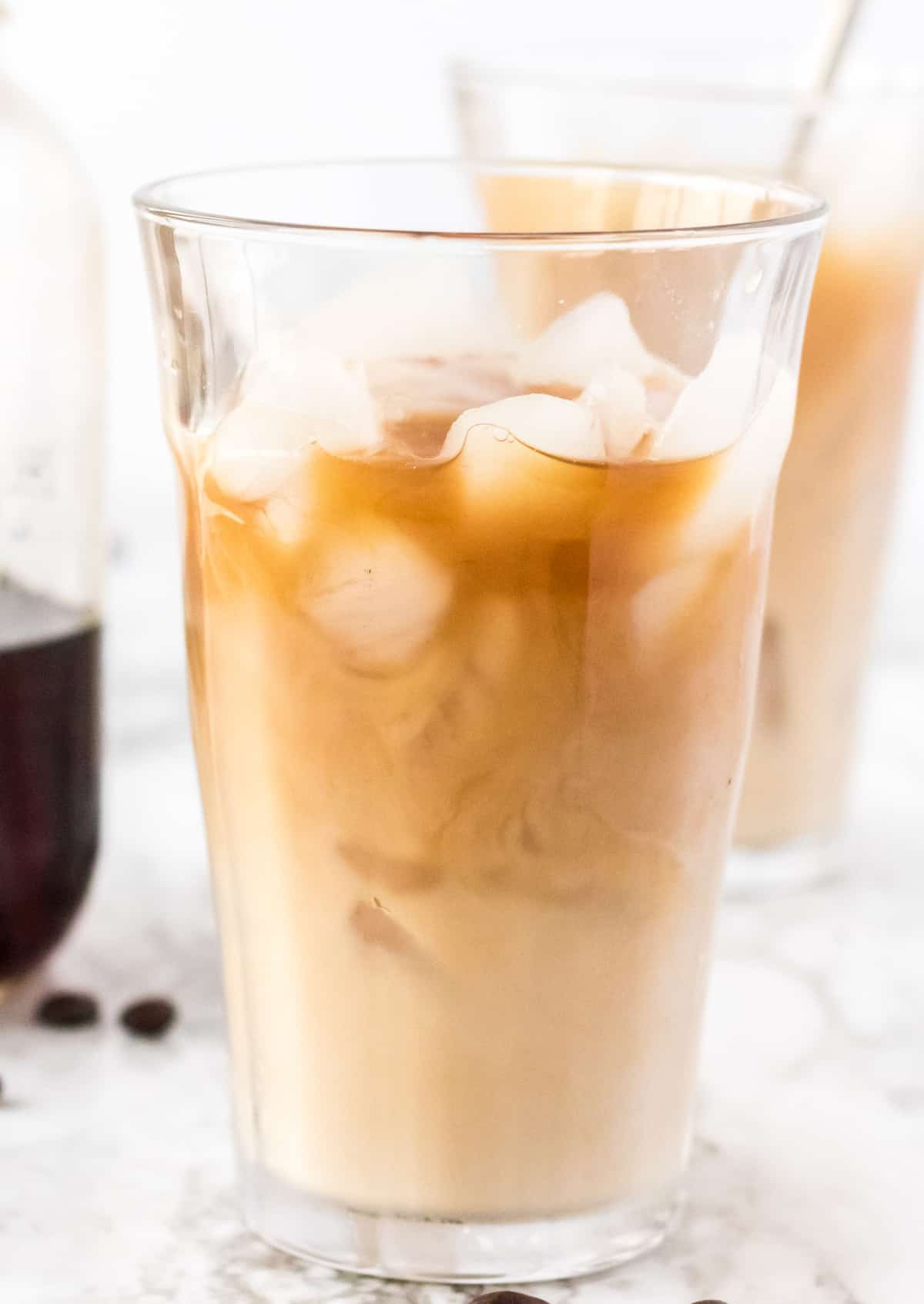 tall glass filled with iced coffee and ice cubes