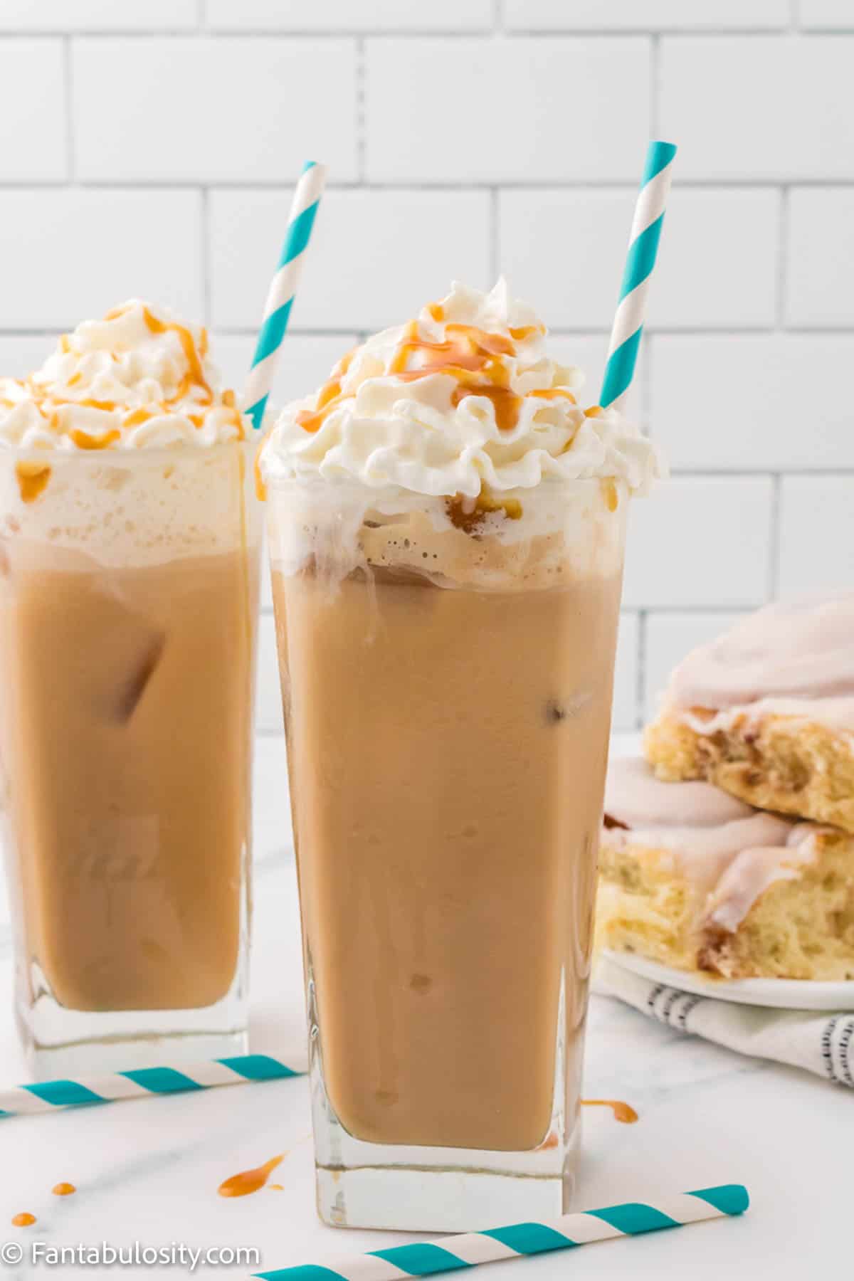 iced caramel lattes in clear glasses with blue straw