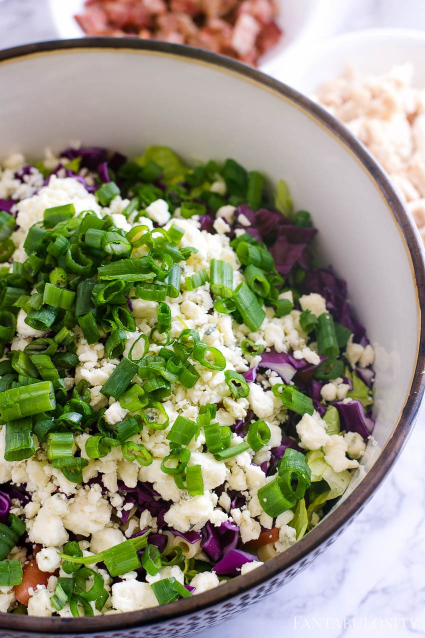 Chopped green onions on top of Italian chopped salad