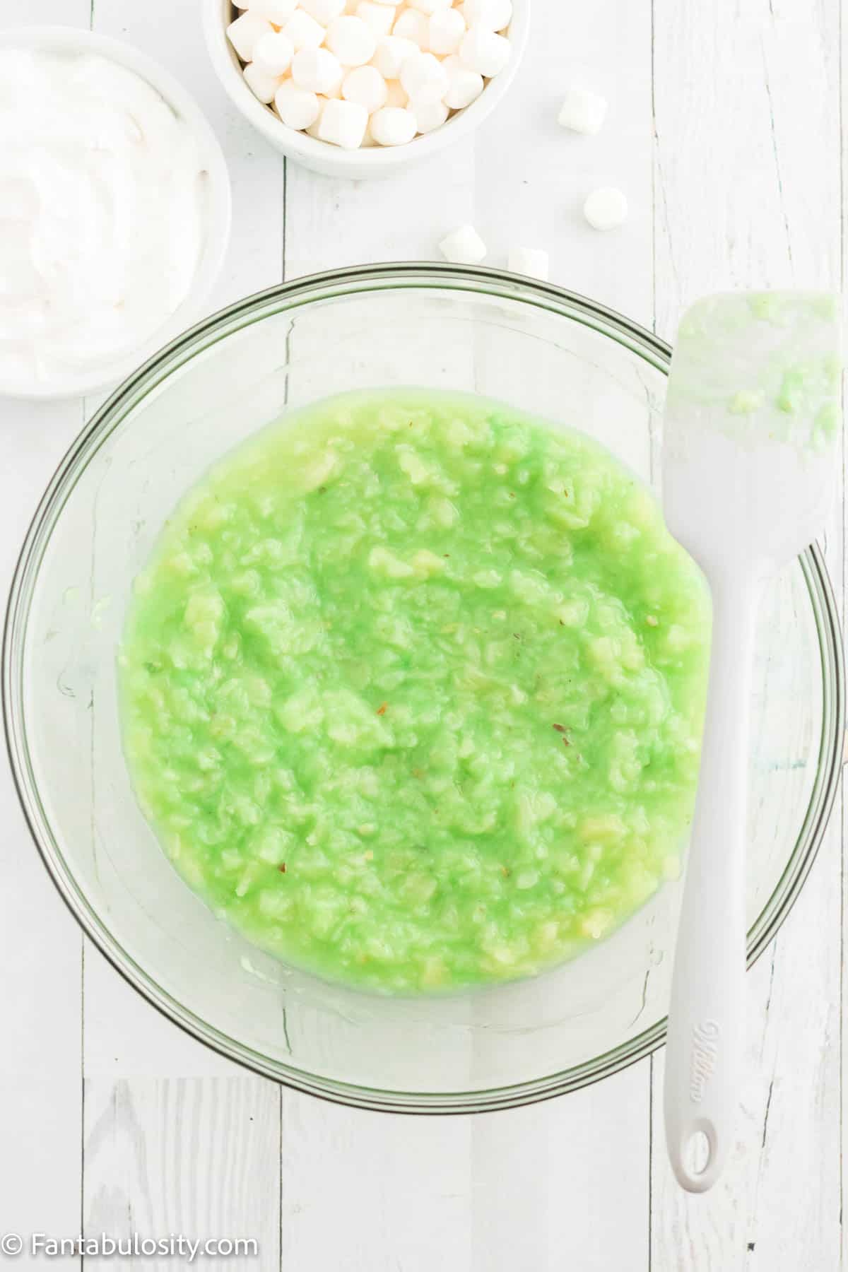 pistachio pudding mix with pineapple in glass bowl